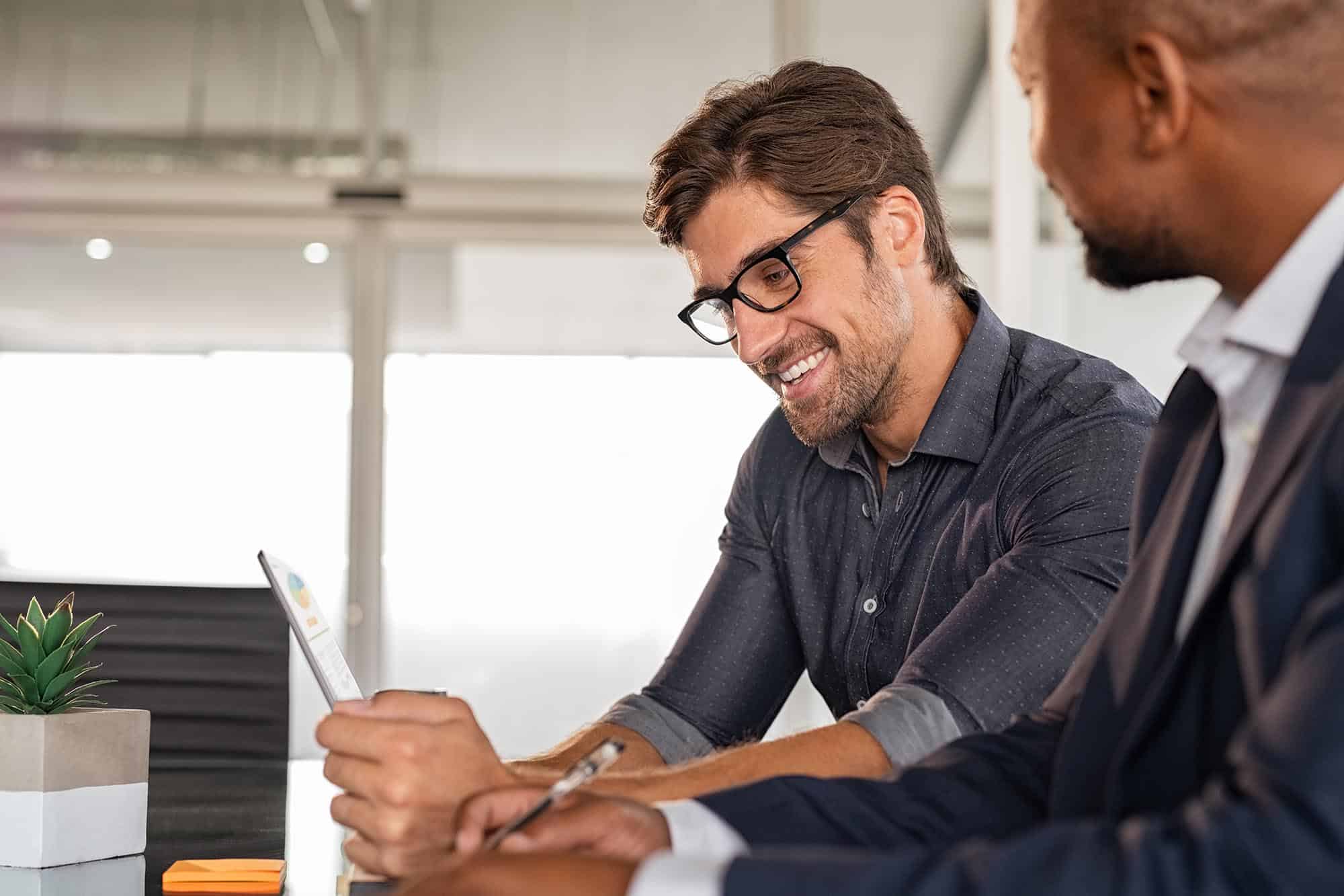 Businessmen working together at desk Residential-Security-Reports